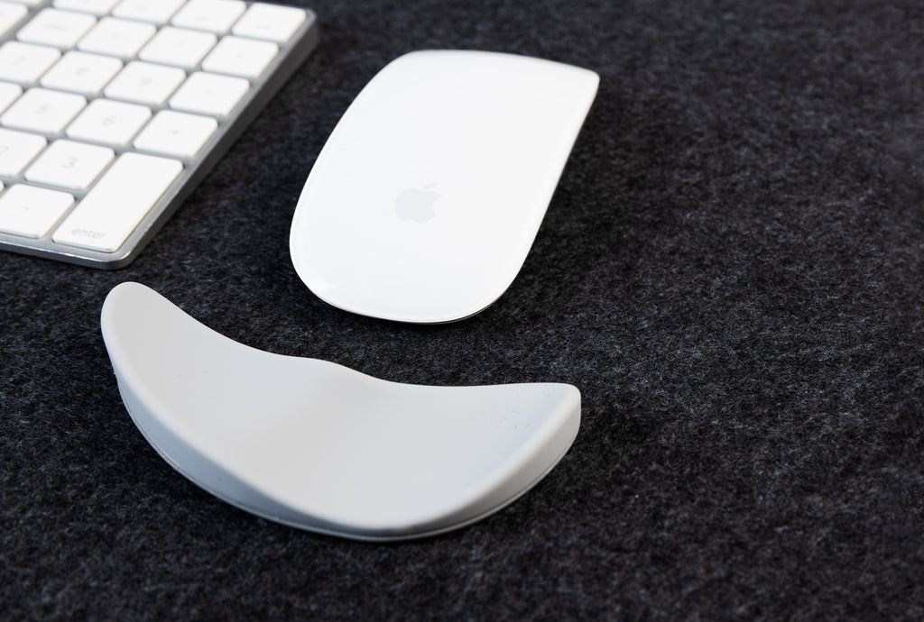 computer mice and wrist support on a felt desk mat