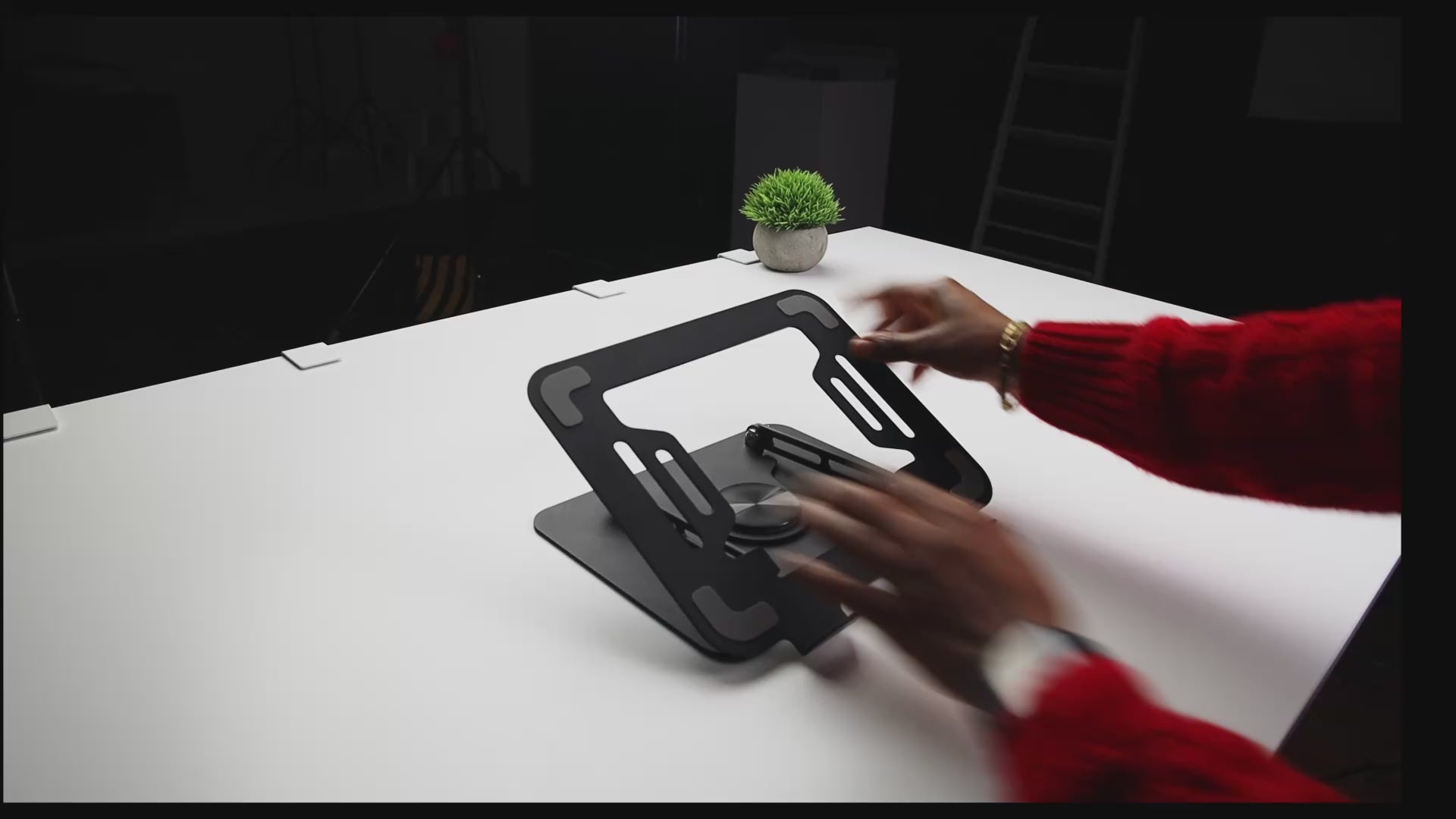 Demonstration of Yelvio Elevate S2 laptop stand rotating 360 degrees and folding flat for storage